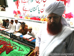 Students keep a vigil at Naeemi's grave. He built a network of religious schools across Pakistan.