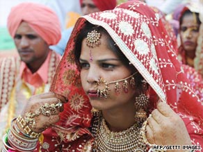 An Indian bride adjusts her headwear during a mass marriage ceremony on the border with Pakistan in April.