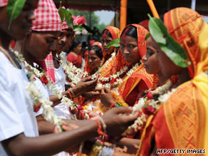 Indian brides and grooms from the Adivasi tribe take part in a mass marriage ceremony.