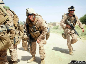 U.S. Marines, under fire from a building, move to take it Saturday in Helmand province, Afghanistan.