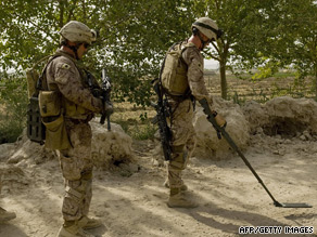 U.S. Marines scan the site of a blast that hit a U.S. vehicle in southern Afghanistan.