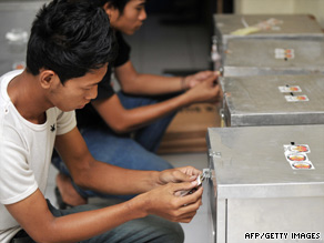 Volunteers in Jakarta seal ballot boxes before officials send them to voting stations.