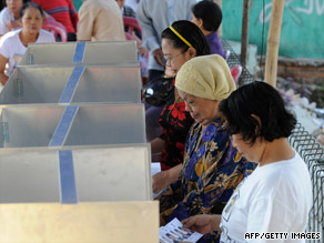 Volunteers in Jakarta seal ballot boxes before officials send them to voting stations.
