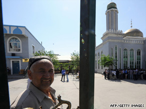 A Chinese Uyghur man opens the gate to a mosque in Urumqi on Thursday during a media tour.