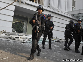 Counter-terrorist police commandos secure the damaged Ritz-Carlton hotel in Jakarta on Friday after the blasts.