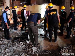 A body is removed following the blasts at the Ritz-Carlton and the nearby J.W. Marriott hotels in Jakarta on Friday.