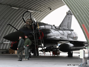 A French Air Force Mirage 2000 sits under a shelter on the tarmac at an airbase in Kandahar on January 1, 2009.