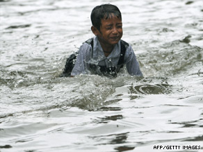 An Indian child plays in a flooded street in Mumbai earlier this month.
