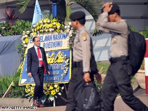 Passersby in front of the Ritz-Carlton hotel in Jakarta, Indonesia, on Thursday.