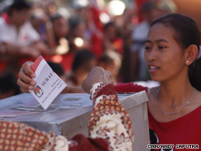 A woman votes at a polling station in Indonesia.
