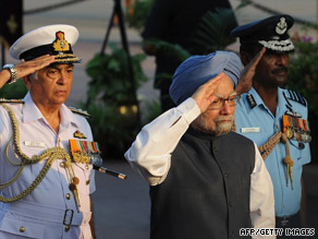 Manmohan Singh, center, honors a war victory in New Delhi on Sunday, the same day he launched a sub.