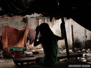Mao Samnag, 28, a former prostitute and HIV positive sits in her shelter in a shanty town in Phnom Penh.