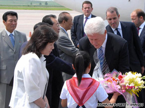 In a North Korean official photo, President Clinton receives flowers on his arrival Tuesday in Pyongyang.