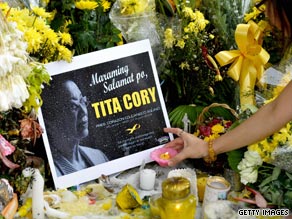 Filipinos light candles outside the home of Corazon 'Cory' Aquino in suburban Quezon city.