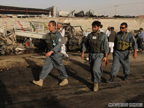 Afghan police survey the scene of a suicide car bomb Tuesday in Kabul, two days before national elections.