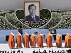 South Korean Buddhist monks pray in front of a portrait of former  president Kim Dae-jung during his funeral Sunday.