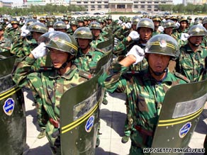 Chinese paramilitary militia chant patriotic slogans during a troop review in Urumqi, China, on July 28.