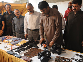 Pakistan security officials show seized weapons and ammunition in Karachi on Sunday after the arrest of seven alleged militants.