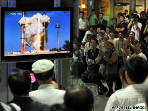 South Koreans at a railway station in Seoul watch the launch of the Korea Space Launch Vehicle-1 Tuesday.