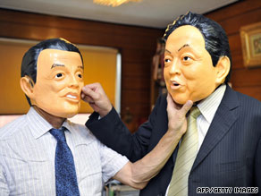 Rubber mask maker staff display masks of Prime Minister Taro Aso, left, and DPJ leader Yukio Hatoyama.