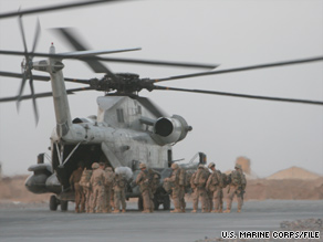 U.S. Marines, with Afghan soldiers and police, board a helicopter at Forward Operating Base Dwyer, Afghanistan.