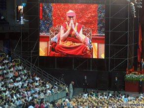 A screen shows the Dalai Lama praying at a ceremony in Kaohsiung, Taiwan, for typhoon victims Tuesday.
