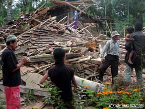 Residents look at a collapsed house in West Java after a major earthquake rocked Indonesia on Wednesday.