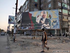 A man walks past a billboard with a photo of Afghanistan's President Hamid Karzai in Kabul on September 6, 2009.