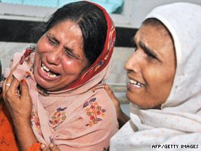 Pakistani women mourn relatives' deaths Monday at a Karachi hospital after a stampede.