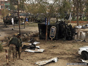Italian soldiers stand near their vehicle, destroyed by a car bomb in Kabul, Afghanistan, on Thursday.