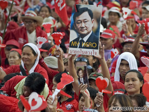 Red-shirted demonstrators hold up a picture of Thaksin Shinawatra at Royal Plaza in Bangkok.