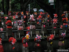 Tiny statues of Jizo, a Japanese deity lines the gardens of the Zojoji temple in Tokyo.