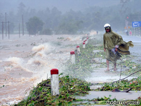 A man walks by a lake alongside the national north-south highway near Danang, Vietnam on September 29, 2009