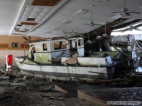 A damaged boat washed up inside a building in Pago Pago, American Samoa.