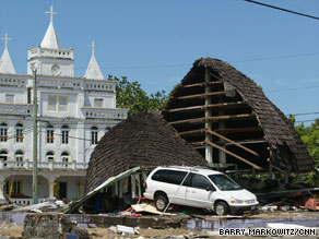 Debris clutters a road Tuesday in Pago Pago. At least 139 people have been confirmed dead.