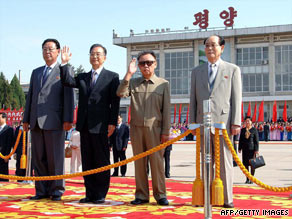 This KCNA photo shows Chinese Premier Wen Jiabao, second left, next to N. Korean leader Kim Jong Il, waving.
