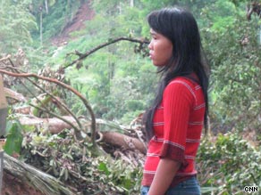 Septiani Lenianingsih watches as villagers and emergency workers dig for bodies.