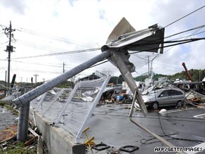 Utility poles lie buckled in the wake of Typhoon Melor.