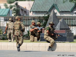 Pakistani soldiers take up position after an attack on the army headquarters in Rawalpindi on October 10.