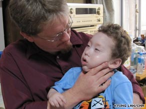 Spencer Morrey, pictured with his father Craig, has severe cerebral palsy and requires 24-hour medical care.