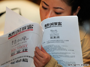 A woman reads the Shanghai-based Hurun Report earlier this week at a Beijing hotel.