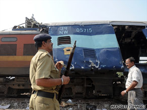 Indian Railway Protection Force personnel look at a damaged carriage after the collision Wednesday.
