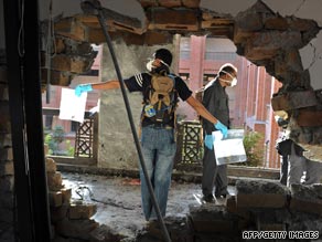 Police investigators collect evidence at the suicide blast site at Islamic International University in Islamabad.