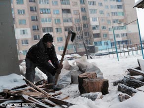 A Bulgarian man chops wood for heating after their gas supplies were cut.