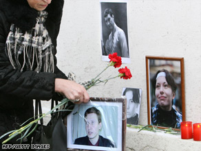 A woman places flowers at the spot where Stanislav Markelov and Anastasiya Baburova were gunned down.
