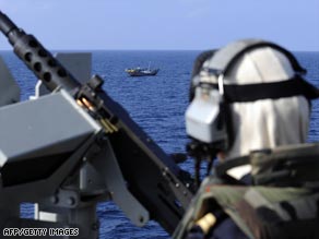 A soldier looks at a Yemeni fishing boat from a French frigate. Spanish troops are due to join the EU task force.