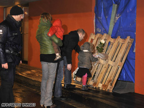 Police stand beside a hearse in front of the childcare centre in Dendermonde where the attack took place.