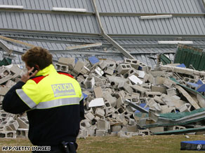 A man turns away from the storm Saturday in western France. High winds have lashed Spain and France.