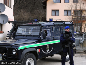 Portuguese peacekeepers stand guard outside a home raided on Tuesday.