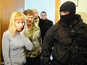 Ukrainian security service agents let employees leave a room at Naftogaz's headquarters.
